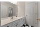 Bathroom with white vanity, black hardware, large mirror and black and white tile flooring at 340 Antebellum Way, Fayetteville, GA 30215