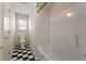 Bathroom featuring a tub/shower combo, toilet, and black and white tile flooring at 340 Antebellum Way, Fayetteville, GA 30215