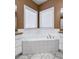 Angle shot of bathroom with corner soaking tub and double windows at 340 Antebellum Way, Fayetteville, GA 30215