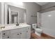 Well-lit bathroom with a modern vanity, a toilet, and a shower-tub combo with tile surround at 340 Antebellum Way, Fayetteville, GA 30215