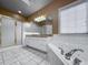 Bathroom with soaking tub, glass enclosed shower, double vanity, and tiled floor at 340 Antebellum Way, Fayetteville, GA 30215