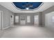 Large, open bedroom featuring a striking blue tray ceiling, ample natural light and gray walls at 340 Antebellum Way, Fayetteville, GA 30215