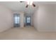 Airy bedroom featuring neutral carpet, a ceiling fan, and natural light from the windows at 340 Antebellum Way, Fayetteville, GA 30215