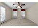 Bedroom with a ceiling fan and access to a balcony, providing comfort and outdoor connection at 340 Antebellum Way, Fayetteville, GA 30215