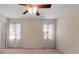 Bedroom with ceiling fan and two windows with blinds and curtains at 340 Antebellum Way, Fayetteville, GA 30215
