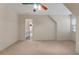 Bright bedroom with neutral carpet, ceiling fan and door to bathroom with black and white tile flooring at 340 Antebellum Way, Fayetteville, GA 30215