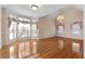 Spacious dining room features hardwood floors, large windows, and decorative window treatments at 340 Antebellum Way, Fayetteville, GA 30215