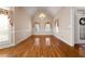 Bright dining room features hardwood floors, neutral walls, and multiple windows with decorative curtains at 340 Antebellum Way, Fayetteville, GA 30215
