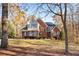 Beautiful two-story brick home with blue shutters, mature trees, and a well-maintained front yard at 340 Antebellum Way, Fayetteville, GA 30215