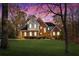 Traditional brick home with beautiful lawn, illuminated windows, and elegant curb appeal at 340 Antebellum Way, Fayetteville, GA 30215