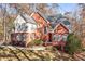 Lovely two-story brick home with blue shutters and a well-manicured lawn surrounded by trees at 340 Antebellum Way, Fayetteville, GA 30215