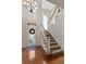 Bright foyer features a chandelier, staircase, hardwood flooring, and a decorative front door with sidelights at 340 Antebellum Way, Fayetteville, GA 30215