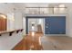 Inviting foyer with wood floors, blue accent wall, and staircase leading to second floor at 340 Antebellum Way, Fayetteville, GA 30215