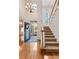 Bright foyer with hardwood floors, staircase, and leaded glass door with seasonal wreath at 340 Antebellum Way, Fayetteville, GA 30215
