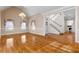 Open-concept living room with hardwood floors, staircase, and natural light at 340 Antebellum Way, Fayetteville, GA 30215