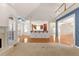 Open-concept living room with fireplace, view of kitchen, and hardwood floors at 340 Antebellum Way, Fayetteville, GA 30215