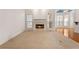 Carpeted living room featuring a fireplace, large windows, and access to other rooms at 340 Antebellum Way, Fayetteville, GA 30215