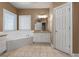 Large main bathroom featuring a soaking tub, white cabinets, and tile flooring at 340 Antebellum Way, Fayetteville, GA 30215