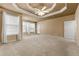 Spacious main bedroom featuring a tray ceiling and large windows allowing ample natural light at 340 Antebellum Way, Fayetteville, GA 30215