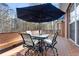 Outdoor deck space, featuring a bar height table with chairs and wooded views at 340 Antebellum Way, Fayetteville, GA 30215