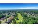 Aerial view of a residential area with tree lined streets, homes, and a golf course creating a beautiful community at 3905 Greenside Ct, Dacula, GA 30019