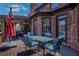 An outdoor dining space on the back porch, accented by a brick exterior at 3905 Greenside Ct, Dacula, GA 30019