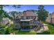 Aerial view of a brick house showcasing a spacious backyard with a patio and a wooden deck overlooking a lawn at 3905 Greenside Ct, Dacula, GA 30019