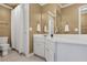 Bright bathroom with white cabinets, white counters, a large mirror, and a shower with a white curtain at 3905 Greenside Ct, Dacula, GA 30019
