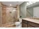 Bathroom featuring a glass shower, tile flooring, and wooden vanity with a granite countertop, all elegantly designed at 3905 Greenside Ct, Dacula, GA 30019