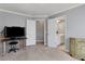 Bedroom with gray walls, an office space, and a view into the bathroom offering a bright and functional layout at 3905 Greenside Ct, Dacula, GA 30019