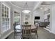 Dining area features a wood table, many windows, and flows into the living room at 3905 Greenside Ct, Dacula, GA 30019