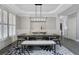 Elegant dining room with modern light fixture, hardwood floors, and white wainscoting at 3905 Greenside Ct, Dacula, GA 30019