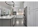 Bright kitchen features white cabinets, stainless steel appliances, and a large island with a white countertop at 3905 Greenside Ct, Dacula, GA 30019