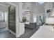 Open kitchen featuring high ceilings, an island with sink, modern countertops, and stainless-steel appliances at 3905 Greenside Ct, Dacula, GA 30019