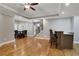 A great room with hardwood floors, a bar, and a dining table at 3905 Greenside Ct, Dacula, GA 30019