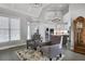 Cozy living area with tufted chairs, rug, and view into the kitchen, with neutral paint at 3905 Greenside Ct, Dacula, GA 30019