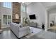 Bright living room with a stone fireplace, large windows, and hardwood floors at 3905 Greenside Ct, Dacula, GA 30019