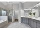 Main bathroom suite with double vanities, a glass shower, and separate soaking tub at 3905 Greenside Ct, Dacula, GA 30019