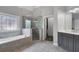 Luxurious main bathroom featuring a glass shower, soaking tub, and custom cabinetry at 3905 Greenside Ct, Dacula, GA 30019