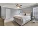 Comfortable main bedroom with tufted headboard, a ceiling fan, crown molding, and two windows offering natural light at 3905 Greenside Ct, Dacula, GA 30019