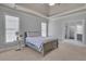 Comfortable main bedroom suite with a king bed, tray ceilings, and many windows at 3905 Greenside Ct, Dacula, GA 30019