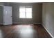 Neutral-toned bedroom with a white door, window, and laminate flooring, creating a serene atmosphere at 1205 Pebble Bend Dr, Grayson, GA 30017