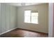 Bright bedroom with vertical paneling and a window with views of the surrounding greenery at 1205 Pebble Bend Dr, Grayson, GA 30017