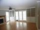 Bright living room with a cozy fireplace, built-in shelving, hardwood floors, and French doors to the outside at 1205 Pebble Bend Dr, Grayson, GA 30017