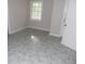 Neutral toned room with marble patterned floors and a white door at 1205 Pebble Bend Dr, Grayson, GA 30017