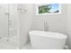 Serene bathroom featuring a sleek, modern freestanding tub and glass-enclosed shower at 156 Club Cir, Stockbridge, GA 30281