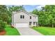 Well-maintained home with an attached garage, green lawn, and a welcoming facade at 156 Club Cir, Stockbridge, GA 30281
