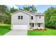 Charming two-story home with a welcoming front porch, attached garage, and well-manicured lawn at 156 Club Cir, Stockbridge, GA 30281