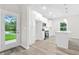 Modern kitchen with white cabinets, stainless appliances, island, and outdoor views through glass door at 156 Club Cir, Stockbridge, GA 30281
