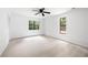 Light-filled carpeted bedroom with windows and closet at 3292 Holly Mill Ct, Marietta, GA 30062